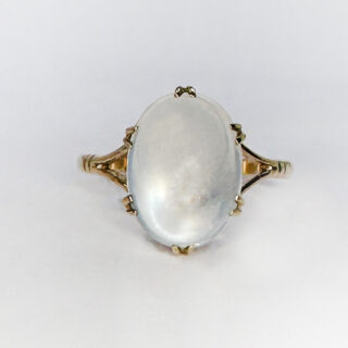 Adorable Art Deco Antique Large Moonstone Ring. The yellow gold shank has split shoulders with the beautiful claw set grey light blue moonstone. The single stone moonstone has a mesmerising chatoyance and measures 13mm x 10mm x 6mm deep. This elegant ring sits well and comfortable on the finger and can be resized. Contact us if you would like more information about buying this ring. 